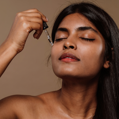 Model showing how to apply AURELA Bio-Lipid Renewal Elixir with dropper to face